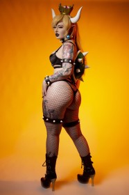 background jaune,bowsette,caucasien,cheveux blond,collant,collant en résille,corps entier,cosplay,couronne,cuisses,cul,culotte,debout,femme,gros cul,grosses cuisses,jambes,jessica luna,lingerie,mario (series),nintendo,oreilles pointues,regarde derrière,résille,rouge a lèvres,sangle de cuisse,soutif,talon aiguille,tatouage