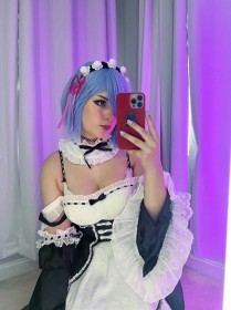 sitting,hairband,caucasian,blue hair,short hair,cosplay,women,non-nude,hair over one eye,re zero,rem (re zero),dress,selfshot,smartphone,blue eyes